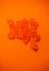 Red Caviar macro shot, Caviar over orange background. Fish roe, Close-up salmon or trout caviar. Delicatessen