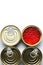 Red caviar of salmon fish. Four tinned metal cans. White background. Flat Lay. Copy space