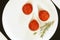 Red caviar in small bowls on white background. top view.