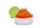 Red caviar spoon and unfocused lime