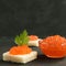 Red caviar on wheat bread on black background,  Sea food. Healthy eating and Diet. Copy space for text