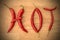 Red Cayenne Chilli Pepper Letters Spelling HOT on Wood
