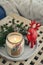 Red ceramic deer and candle in jar with fir tree branches