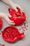 Red ceramic tableware with pomegranate and baby`s hands