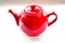 Red ceramic teapot on white background