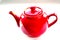 Red ceramic teapot on white background