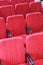 Red chair close-up.  Rows seats in empty movie theater.