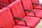 Red chair close-up.  Rows seats in empty movie theater.