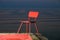 Red chair on a lagoon background. Lithuania, Nida