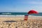 Red chair and red umbrella on a sunny day at the beach