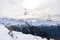 Red chairlift in winter with rear side of mount matterhorn in Switzerland