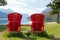 Red chairs on the bank of a lake in the Waterton lakes national park in Canada