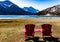 Red chairs and views from at Cameron Bay. Waterton Lakes National Park Alberta Canada