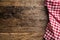 Red checkered kitchen tablecloth on rustic wooden table