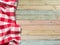 Red checkered picnic tablecloth on colorful wood table