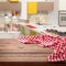 Red checkered tablecloth on wooden table. Napkin close up top view mock up. Kitchen rustic background.