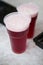 Red cherry beer in a plastic cups