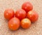 Red cherry tomatoes on the cork background