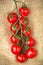 Red cherry tomatoes twig on sacking