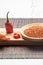Red chili pepper sliced and Chilli powder scattered â€‹â€‹on wooden base on white background. .Gastronomy and cooking condiments