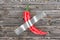Red Chili Pepper Taped to Rustic Plank Wooden Wall. 3d Rendering