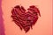 Red chili peppers in heart shape, for valentine\\\'s day on pink background.Top view. Generative AI