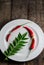 Red chilies with curry leaf on plate