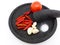 Red chilies, garlics, tomato, and salt on stone ware