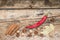 Red Chilli Pepper with other Spices on textured wooden Background