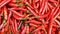 Red chillies background with selective focus on sale in a night market
