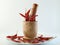 Red chillies with mortar and pestle on white background