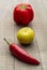 Red chilly, lemon, garlic and a capsicum in a wooden background