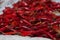 Red chilly peppers in a pile for sale