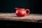 red Chinese gaiwan on an old wooden table