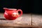 red Chinese gaiwan on an old wooden table