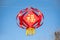 Red Chinese lantern bearing the Chinese character fu, meaning good fortune or happiness, hanging against a clear blue sky