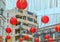 Red Chinese lantern garlands used as decorations before Chinese New year celebration hang outdoors on building background