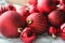 Red Christmas background, bunch of balls for Christmas tree close up, Christmas decorations. Christmas card, and new year, congrat