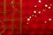 Red Christmas background with a Chinese partition fragment and willow twigs