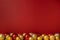 Red Christmas background with red and yellow baubles, copy space