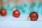 Red Christmas balls with decoration on shiny background with snowflakes