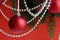 Red christmas balls with garland hang on a red background