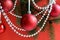 Red christmas balls with garland hang on a red background