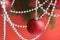 Red christmas balls with garland hang on a red background