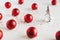 Red Christmas balls, small decorative Christmas tree and colorful glitters on white background