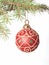 Red Christmas bauble on fir-tree brunch