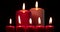 Red Christmas candles burns on dark background