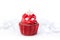 Red christmas cupcake on bright lights background