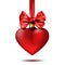 Red Christmas decoration shape of heart hanging on ribbon with bow.