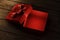Red christmas gift on vintage wooden table from above. Open present box for xmas and new year holiday. Empty giftbox for product